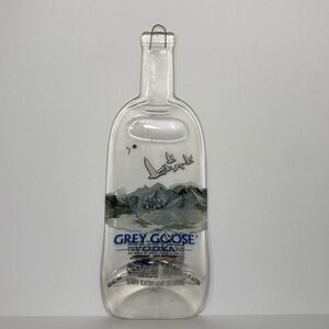 Gray goose vodka glass melted flattened slouched bottle bar decor.